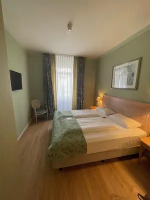 Ein Bett oder Betten in einem Zimmer der Unterkunft Hotel Am Mühlenteich