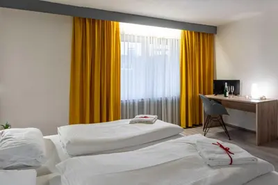 Ein Bett oder Betten in einem Zimmer der Unterkunft Hotel Wildpferd Dülmen