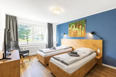 Ein Bett oder Betten in einem Zimmer der Unterkunft Glück Auf Appartements Am Stadtpark Duisburg