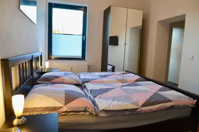Ein Bett oder Betten in einem Zimmer der Unterkunft Gästehaus LeLo 3