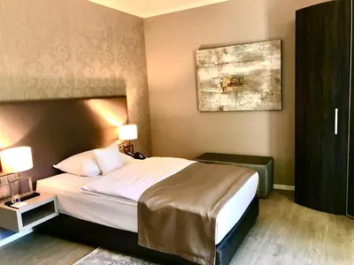 Ein Bett oder Betten in einem Zimmer der Unterkunft Park Villa Hotel