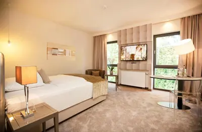 Ein Bett oder Betten in einem Zimmer der Unterkunft Park Villa Hotel