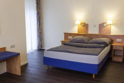 Ein Bett oder Betten in einem Zimmer der Unterkunft Hotel Restaurant Waldlust