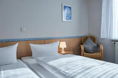 Ein Bett oder Betten in einem Zimmer der Unterkunft Hotel Zum Grunewald