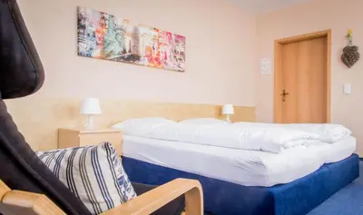 Ein Bett oder Betten in einem Zimmer der Unterkunft Hotel Zum Grunewald