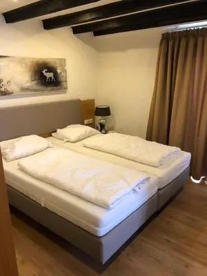 Ein Bett oder Betten in einem Zimmer der Unterkunft Hotel & Gastropark Loemühle