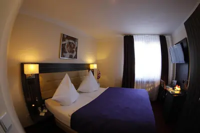 Ein Bett oder Betten in einem Zimmer der Unterkunft Hotel Famosa