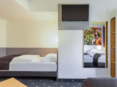 Ein Bett oder Betten in einem Zimmer der Unterkunft B&B HOTEL Dortmund-Messe