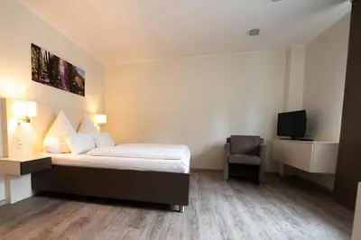 Ein Bett oder Betten in einem Zimmer der Unterkunft Hotel am Tiergarten