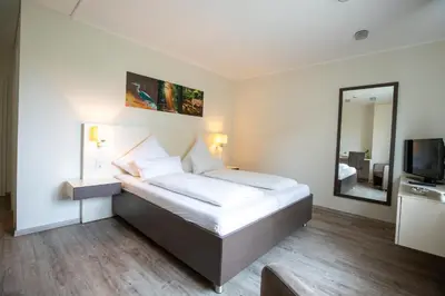 Ein Bett oder Betten in einem Zimmer der Unterkunft Hotel am Tiergarten