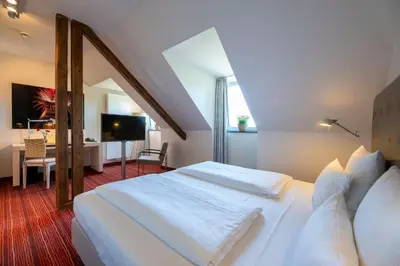 Ein Bett oder Betten in einem Zimmer der Unterkunft Hotel An der Gruga