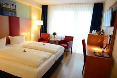 Ein Bett oder Betten in einem Zimmer der Unterkunft Hotel National Düsseldorf (Superior)