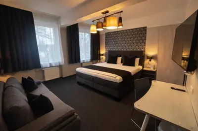 Ein Bett oder Betten in einem Zimmer der Unterkunft Arena Hotel