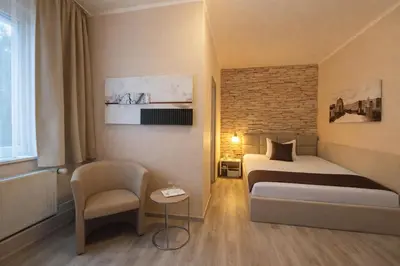 Ein Bett oder Betten in einem Zimmer der Unterkunft Arena Hotel