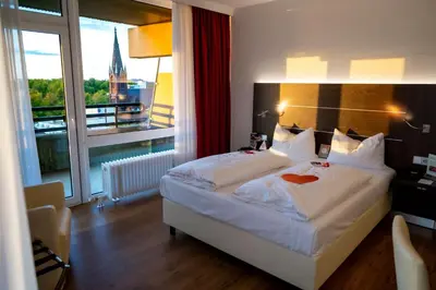 Ein Bett oder Betten in einem Zimmer der Unterkunft Hotel Rheingarten