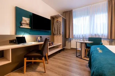 Ein Bett oder Betten in einem Zimmer der Unterkunft Akzent Hotel Gut Höing