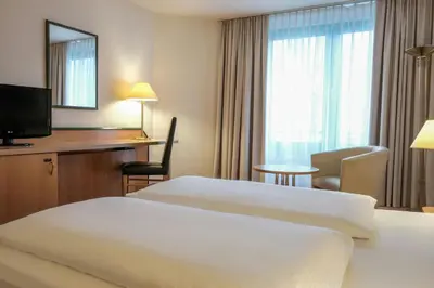Ein Bett oder Betten in einem Zimmer der Unterkunft FOUR Essen City Centre