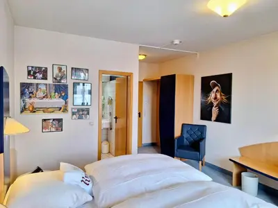 Ein Bett oder Betten in einem Zimmer der Unterkunft Retro - Art - Hotel Lünen