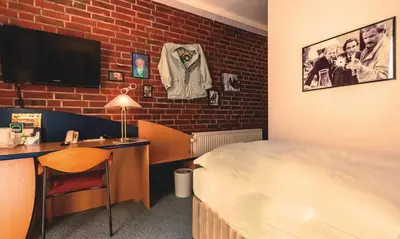 Ein Bett oder Betten in einem Zimmer der Unterkunft Retro - Art - Hotel Lünen