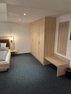 Ein Bett oder Betten in einem Zimmer der Unterkunft Hotel Am Vogelsanger Weg