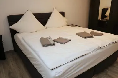 Ein Bett oder Betten in einem Zimmer der Unterkunft Aparthotel Kompass A 401