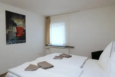 Ein Bett oder Betten in einem Zimmer der Unterkunft Aparthotel Kompass A 401
