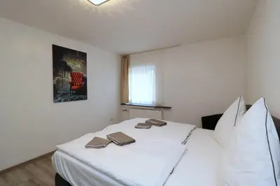 Ein Bett oder Betten in einem Zimmer der Unterkunft Aparthotel Kompass A 401