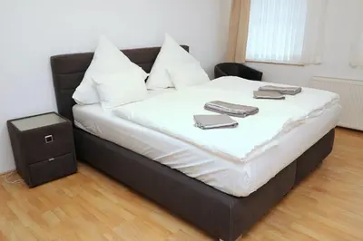 Ein Bett oder Betten in einem Zimmer der Unterkunft Aparthotel Kompass A 404
