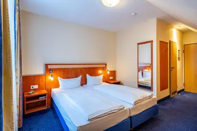 Ein Bett oder Betten in einem Zimmer der Unterkunft Waldhotel Eskeshof