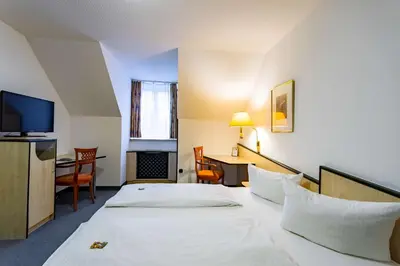 Ein Bett oder Betten in einem Zimmer der Unterkunft Waldhotel Eskeshof
