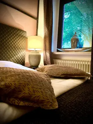 Ein Bett oder Betten in einem Zimmer der Unterkunft Hotel Am Volksgarten