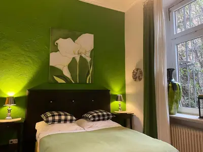 Ein Bett oder Betten in einem Zimmer der Unterkunft Hotel Am Volksgarten