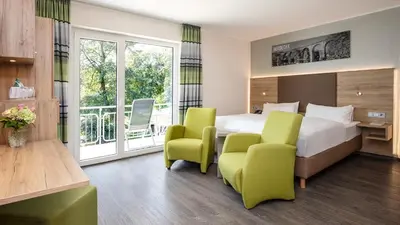 Ein Bett oder Betten in einem Zimmer der Unterkunft Ringhotel Zweibruecker Hof