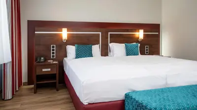 Ein Bett oder Betten in einem Zimmer der Unterkunft Ringhotel Zweibruecker Hof