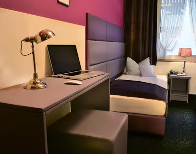 Ein Bett oder Betten in einem Zimmer der Unterkunft Hotel Am Wehrhahn