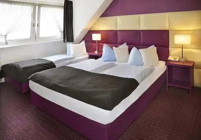 Ein Bett oder Betten in einem Zimmer der Unterkunft Hotel Am Wehrhahn