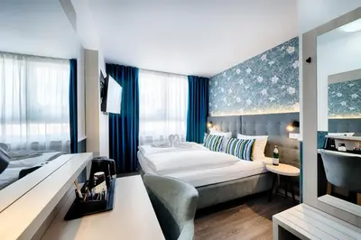 Ein Bett oder Betten in einem Zimmer der Unterkunft Home Hotel