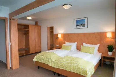 Ein Bett oder Betten in einem Zimmer der Unterkunft Hotel Mingarden