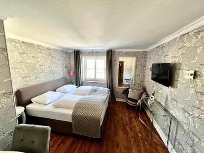Ein Bett oder Betten in einem Zimmer der Unterkunft Hotel Ashley's Garden