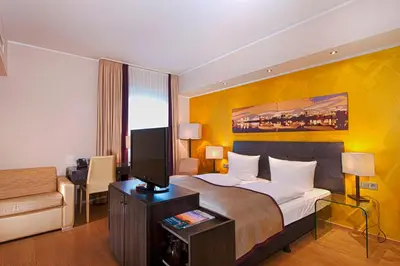 Ein Bett oder Betten in einem Zimmer der Unterkunft Wyndham Duisburger Hof