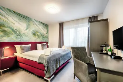 Ein Bett oder Betten in einem Zimmer der Unterkunft Hotel Fürst Garden