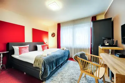 Ein Bett oder Betten in einem Zimmer der Unterkunft Hotel Fürst Garden