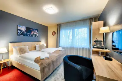 Ein Bett oder Betten in einem Zimmer der Unterkunft Hotel Fürst Garden