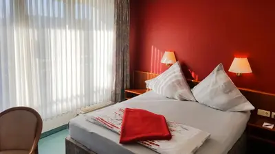 Ein Bett oder Betten in einem Zimmer der Unterkunft Hotel Am Düsseldorfer Platz