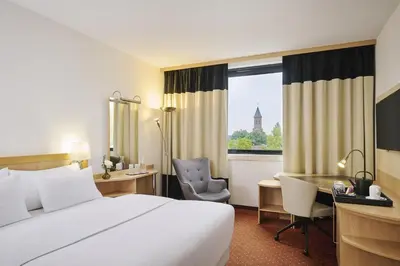 Ein Bett oder Betten in einem Zimmer der Unterkunft NH Oberhausen