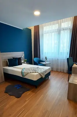 Ein Bett oder Betten in einem Zimmer der Unterkunft New Work Hotel Essen