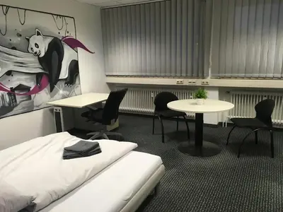 Ein Bett oder Betten in einem Zimmer der Unterkunft Hostel Hamm by Geronimo