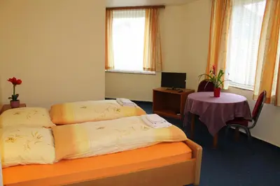 Ein Bett oder Betten in einem Zimmer der Unterkunft Hotel Hubbert