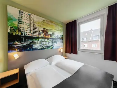 Ein Bett oder Betten in einem Zimmer der Unterkunft B&B Hotel Düsseldorf City-Süd