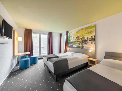 Ein Bett oder Betten in einem Zimmer der Unterkunft B&B Hotel Düsseldorf City-Süd